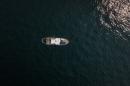 An aerial view of a ship on the calm ocean water.